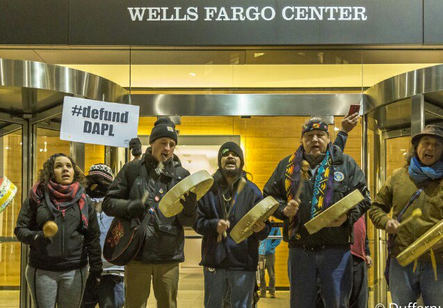 Seattle activists stand in front of Wells Fargo asking them to divest from the Dakota Access Pipeline