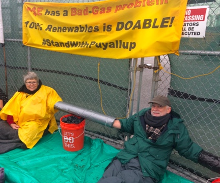 Activists at Puget Sound Energy stage a sit-in with their arms in PVC lock-on