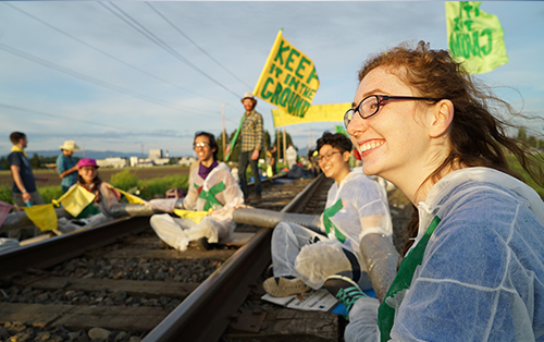Keep it in the Ground activists sit on railroad tracks