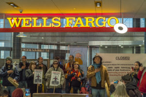 Divestment campaign activists in front of Wells Fargo bank in Seattle