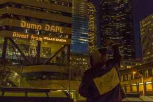 Dump DAPL message projected on exterior wall of financier Wells Fargo